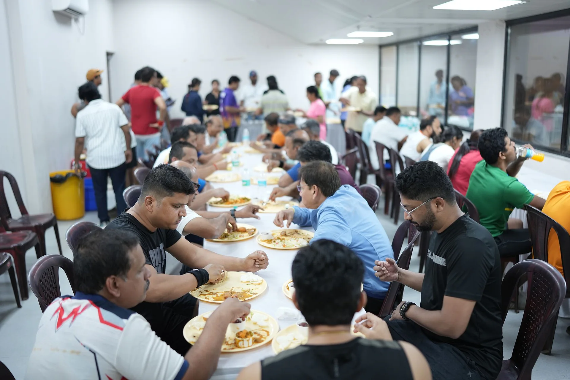 Players and organisers sharing a meal together at a badminton championship