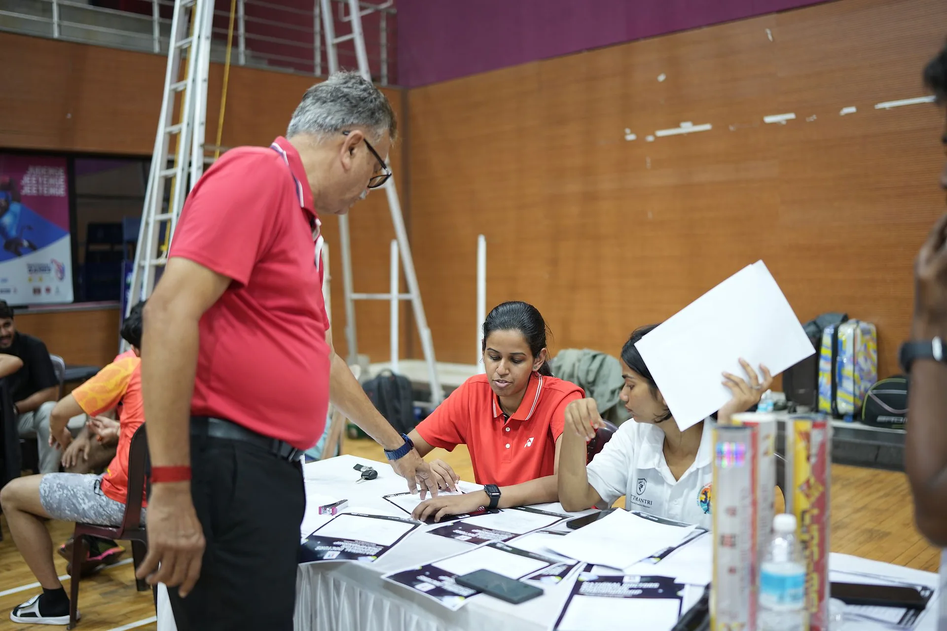 Organisers and players at the tournament desk