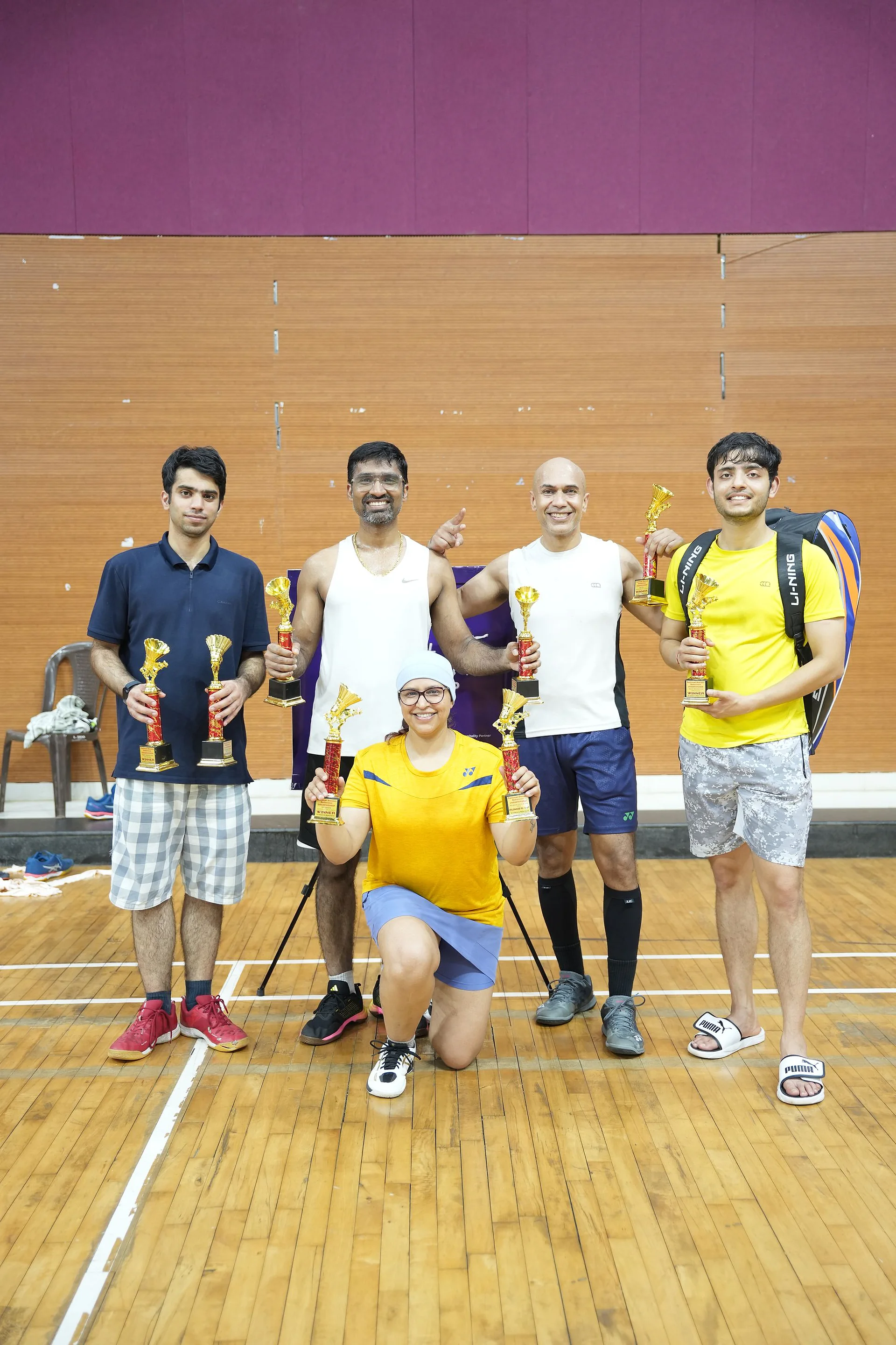 Winners and runners-up holding trophies after the finals