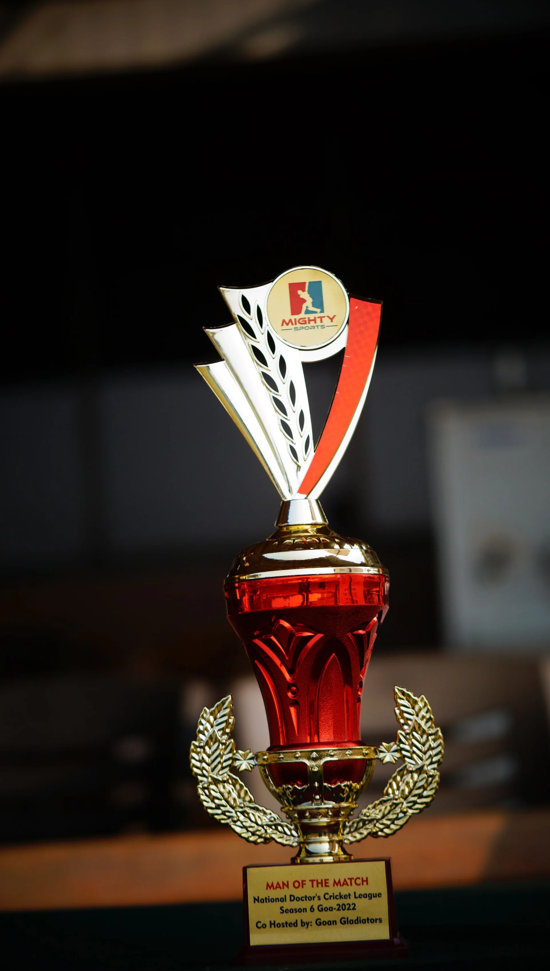 A red and gold Mighty Sports trophy on display